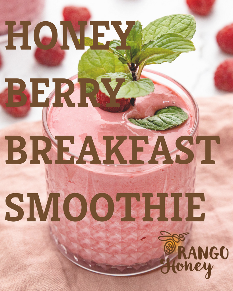 honey and berry smoothie in glass with strawberries